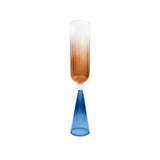 A single bespoke & handblown borosilicate champagne glass with gradient amber color, curved rim. Azure blue stand on a white background