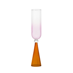A single bespoke & handblown borosilicate champagne glass with gradient rose pink color, curved edged rim. Amber reddish-coloured stand on a white background. Designed for stemware use.